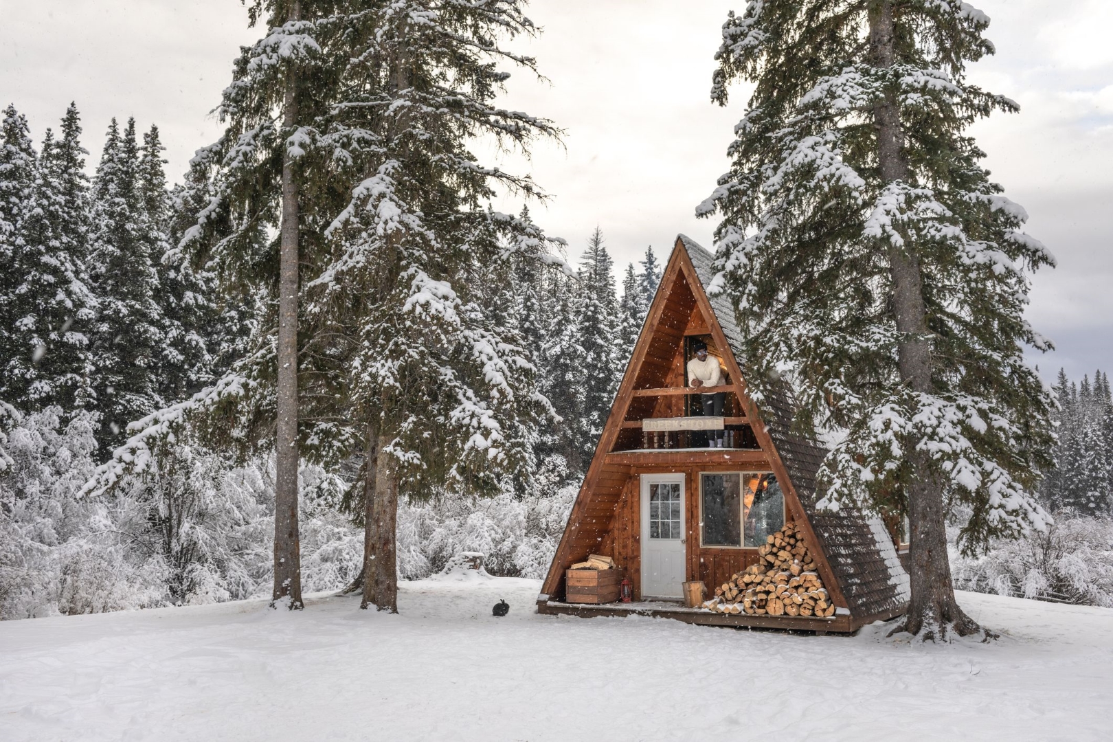 A-frame mountain cabin in a snowy landscape